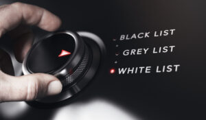 hands turning a dial to select the words white list