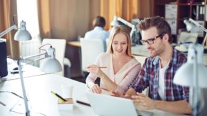 Colleagues sharing ideas on a laptop