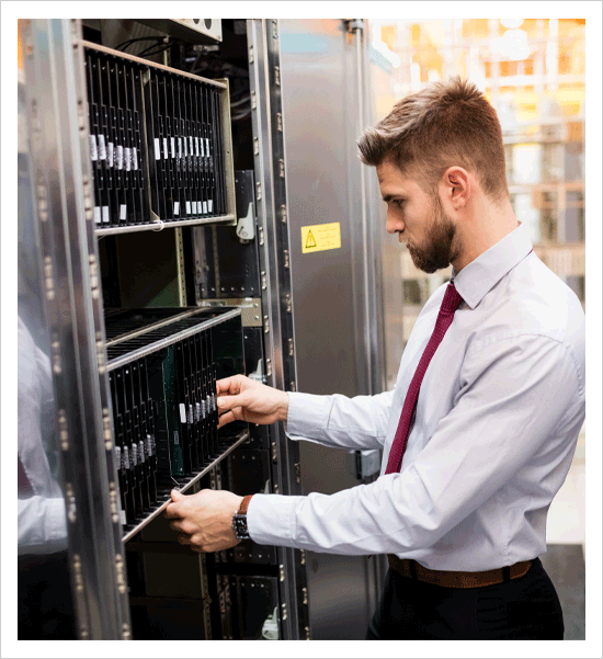 IT engineer looking at server cabinet