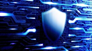 Cybersecurity shield logo in front of circuitry