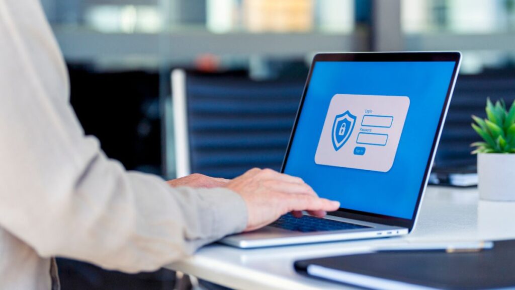 Someone on laptop using a password manager