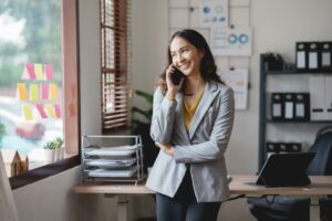 asian woman using a cell phone in an office