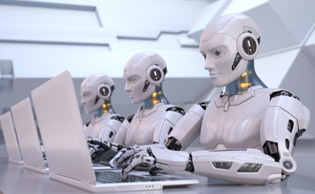 three humanoid robots using laptops